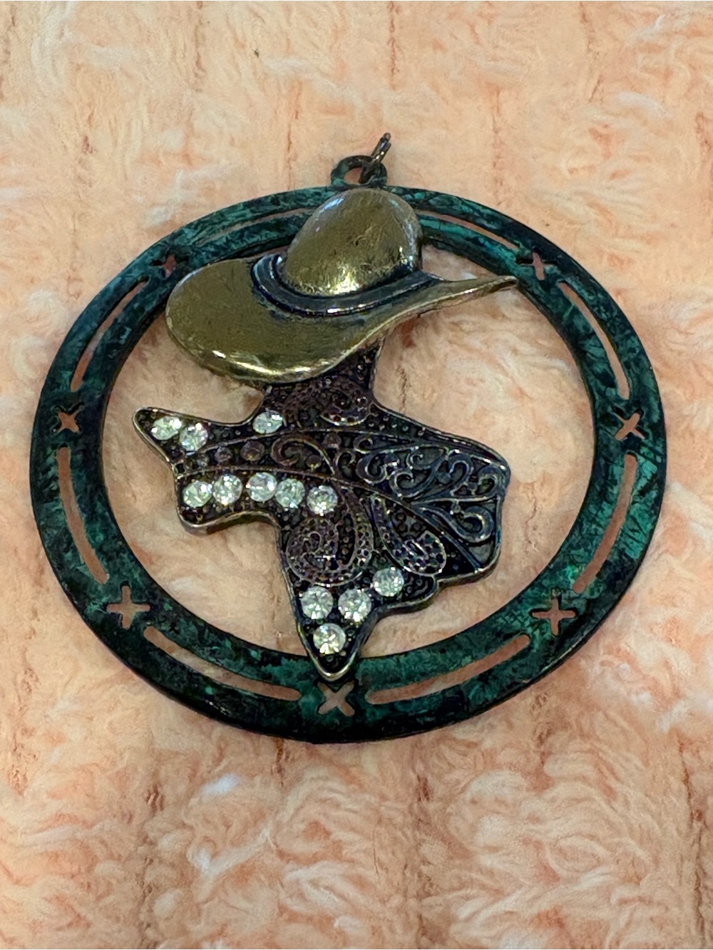 Western style pendant featuring a silhouette of a cowgirl with a gold Tone hat.